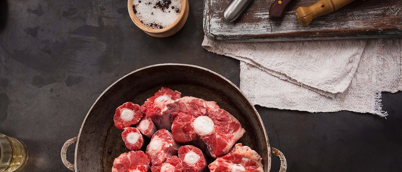 Raw oxtail from Christensen Ranch, showcasing its rich marbling and bone structure. Perfect for slow-cooked recipes like stews and braises, the oxtail is known for its depth of flavor and tender texture when prepared